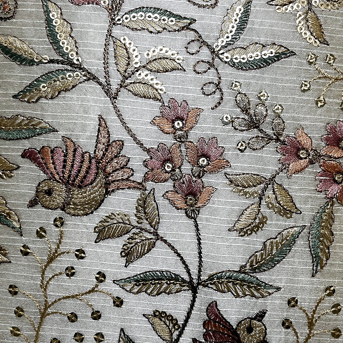 Close-up of the bird and flower embroidery