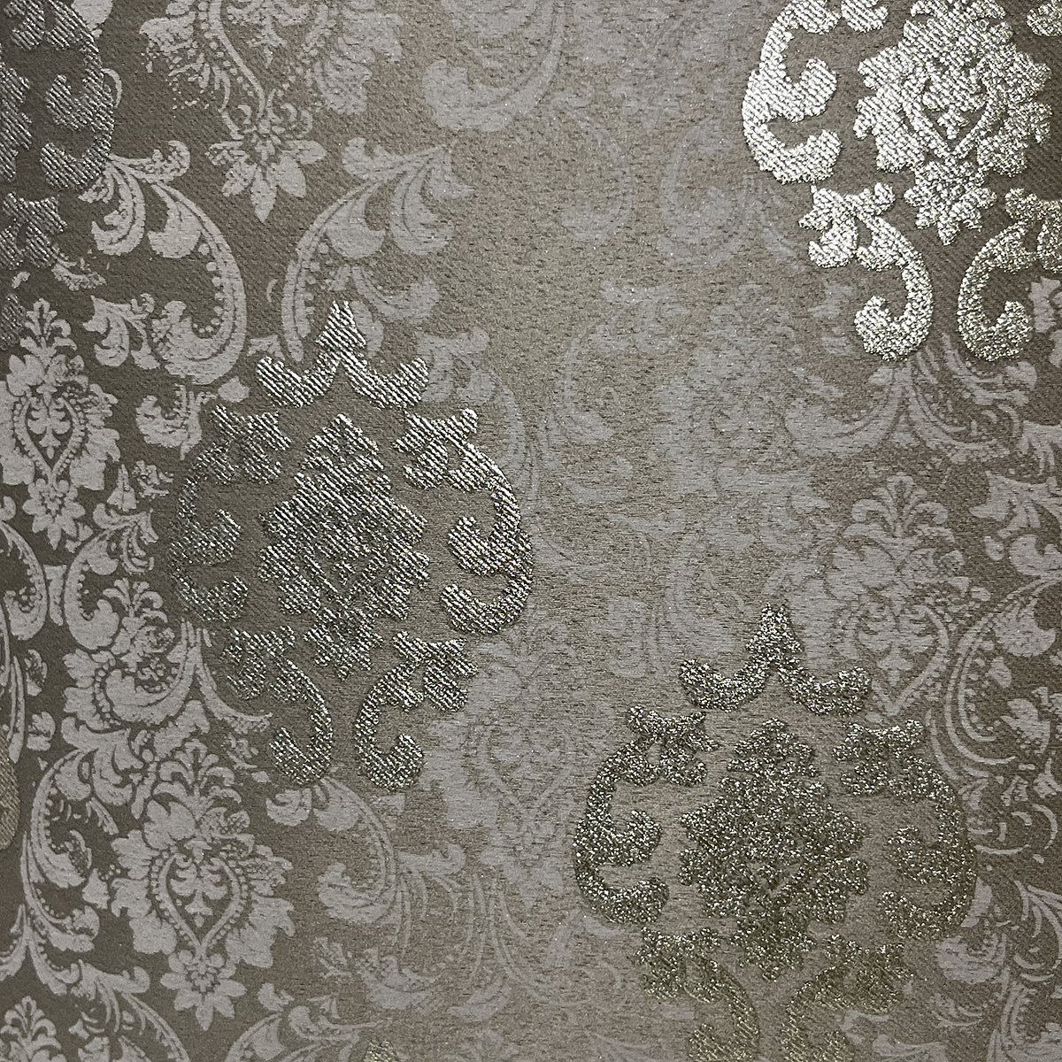 Close-up of the damask weave and gold-toned motifs in brown