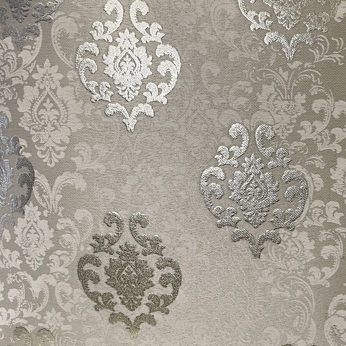 Close-up of the damask weave and gold-toned motifs in champagne gold