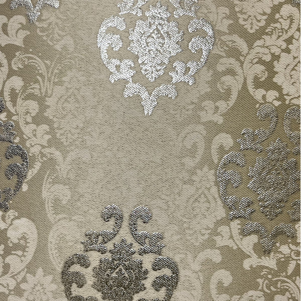Close-up of the damask weave and gold-toned motifs in cream